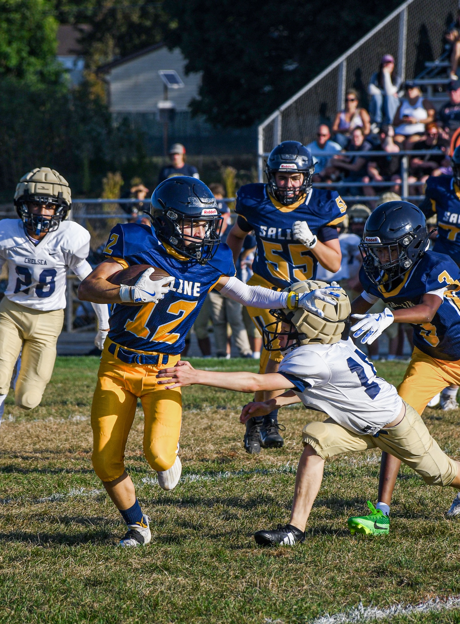 Can't Touch This — award-winning photo of a running back cutting past a diving tackler